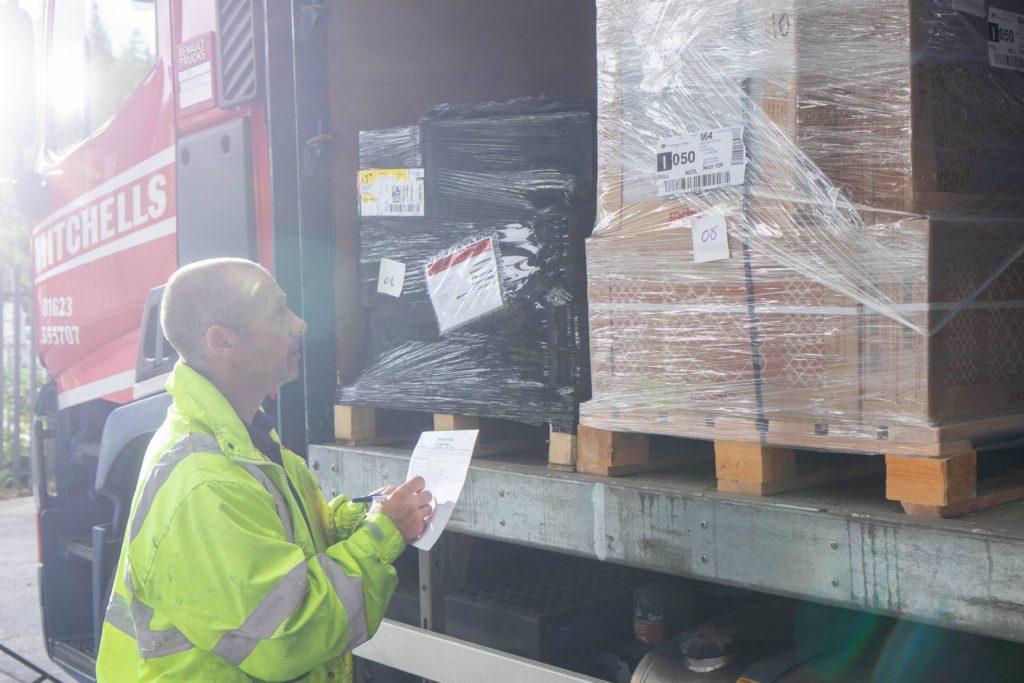 Man checking truck pallet shipment